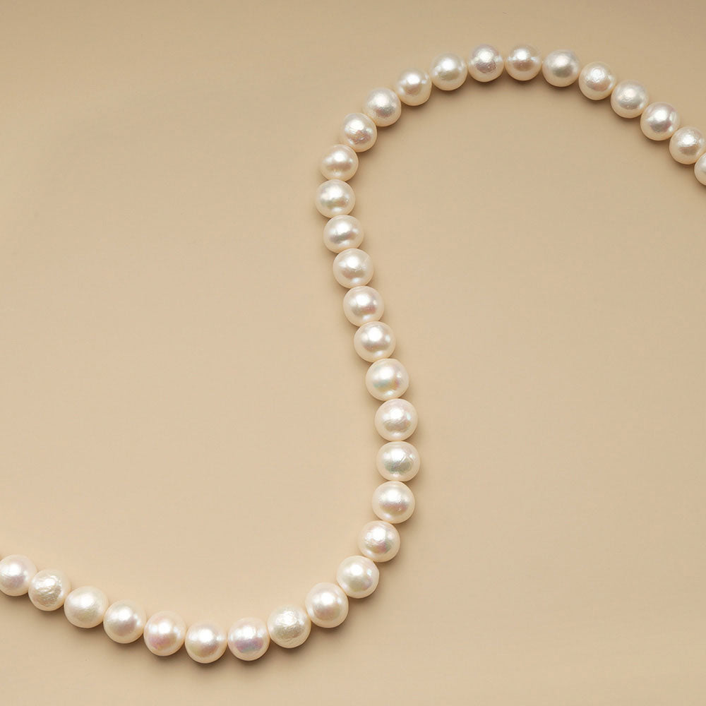 A string of 11mm white pearl beads.