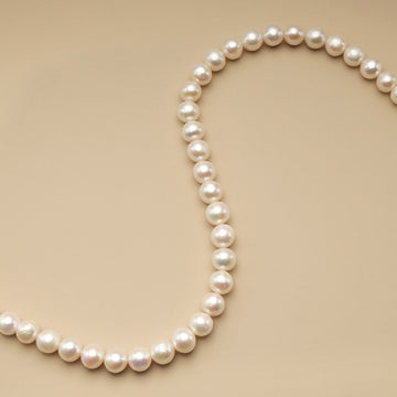 A string of 11mm white pearl beads.