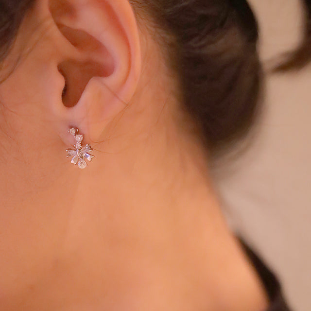 Silver ear studs on women ear.