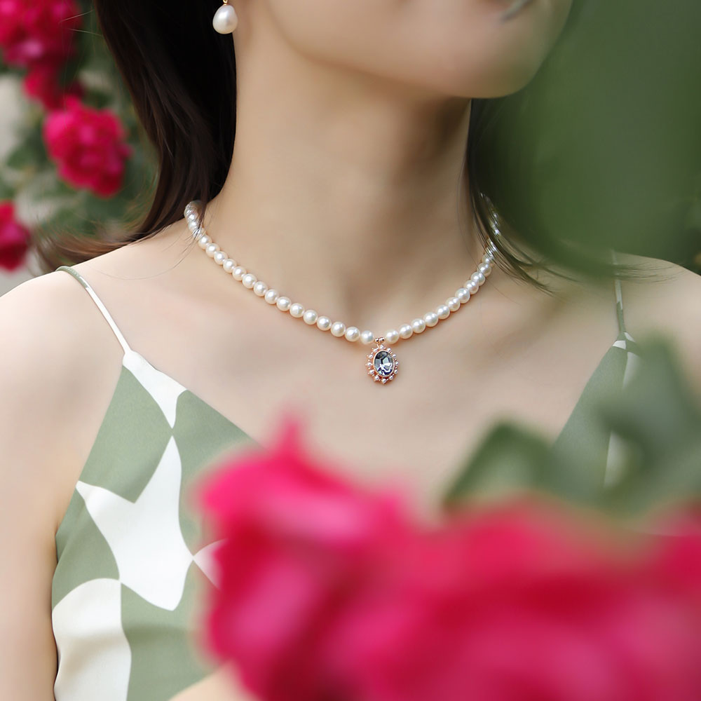 Women wear a aquamarine crystal necklace.