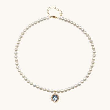 A aquamarine pendant necklace with pearl beads.