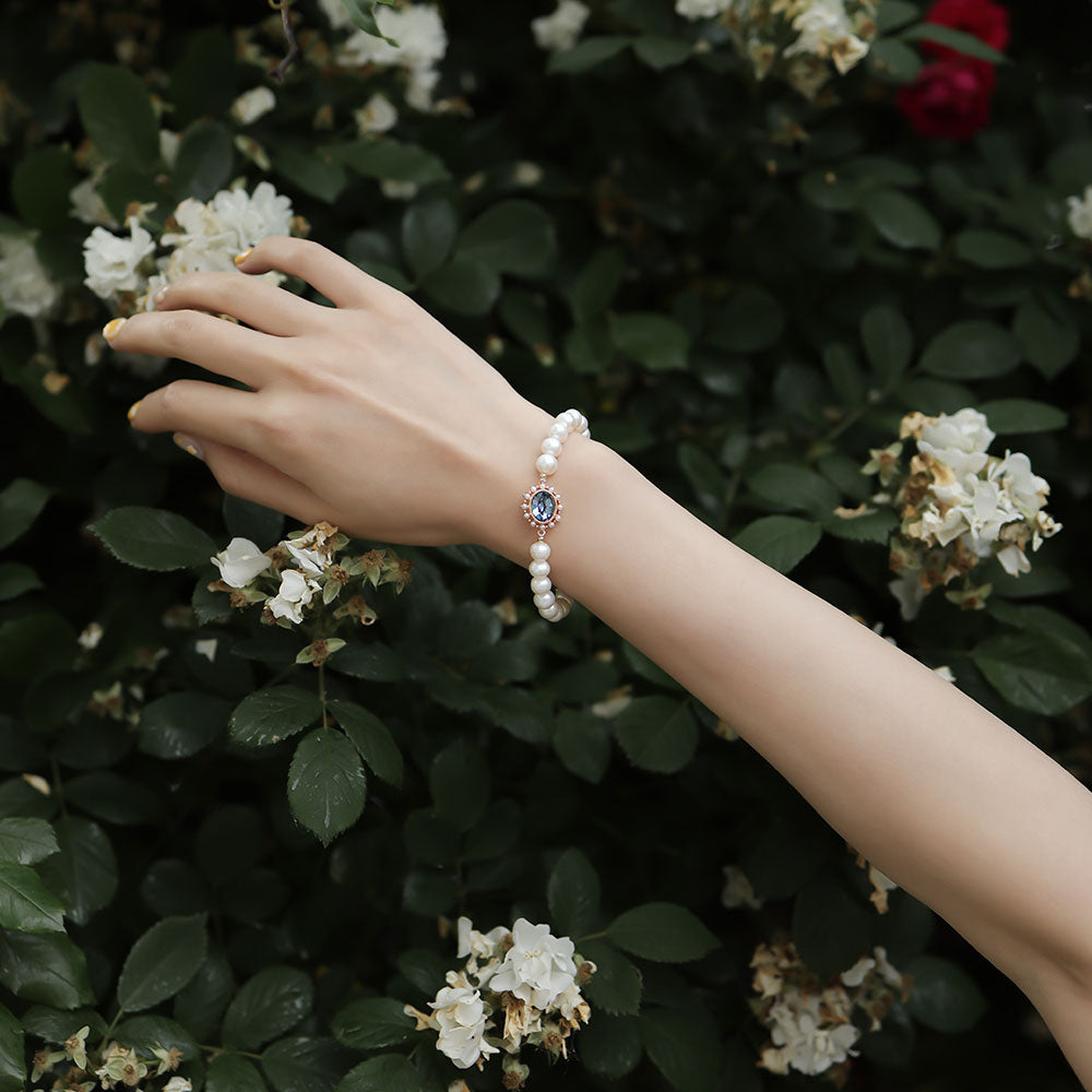 Women wear aquamarine pearl bracelet.