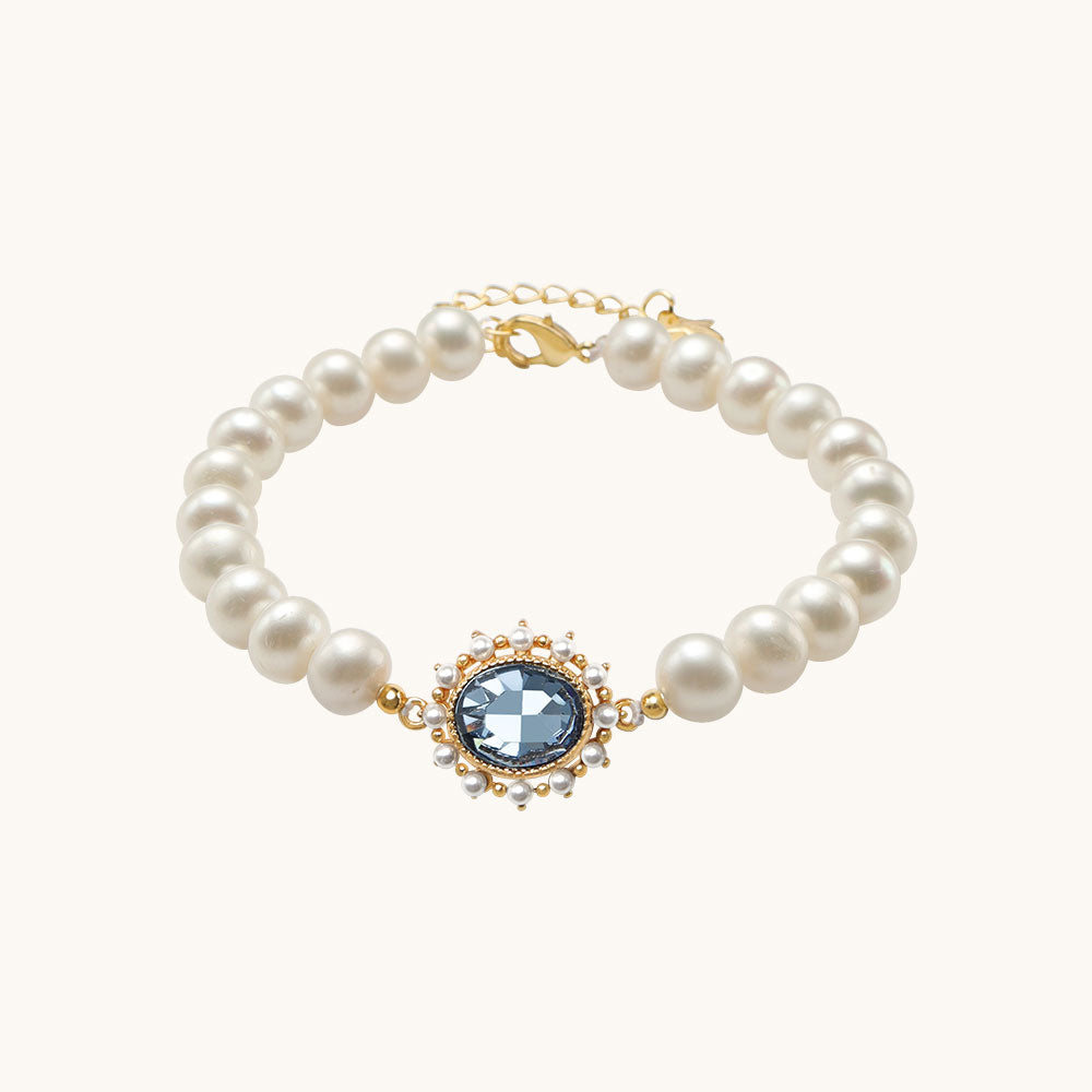 A aquamarine stone bracelet with pearl beads.