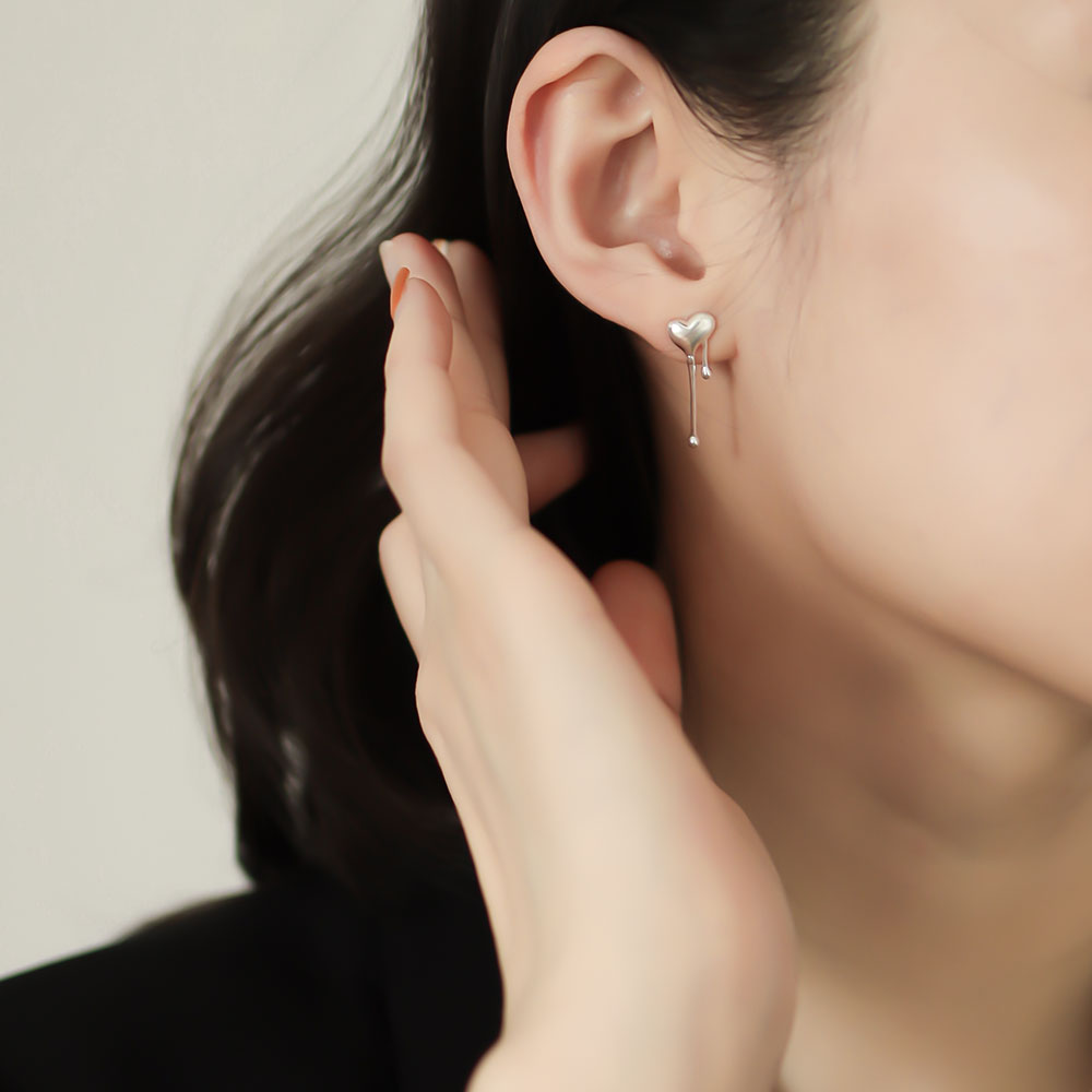 Women wear asymmetrical earrings in silver.