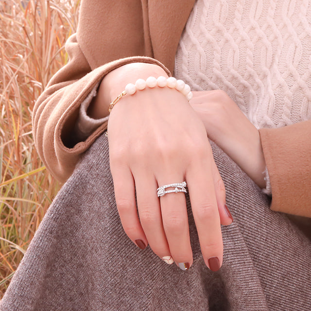 Women wear diamond ring and pearl bracelet.