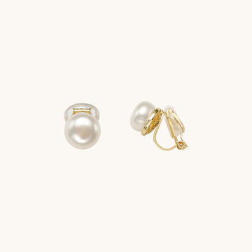 A pair of clip on pearl earrings.