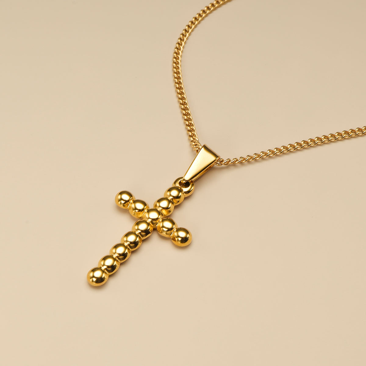 The close shot of cross pendant necklace.