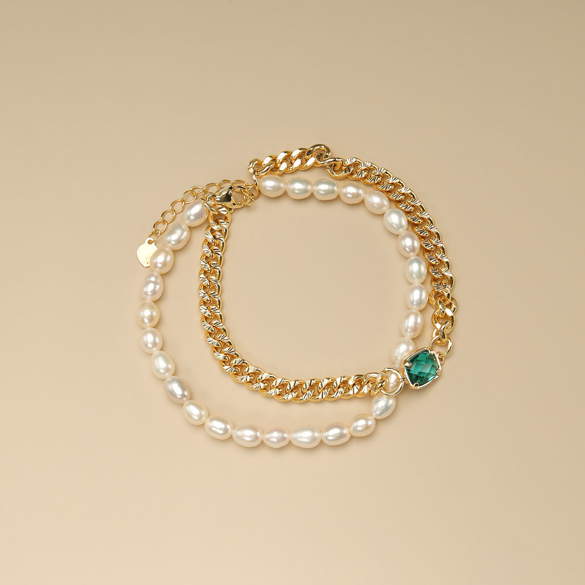 A cuban link bracelet and pearl beaded bracelet.
