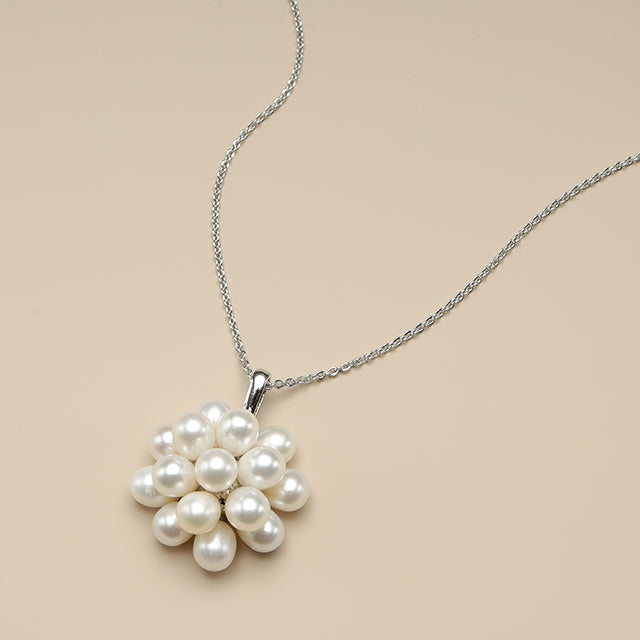 The side shot of dainty pearl necklace.