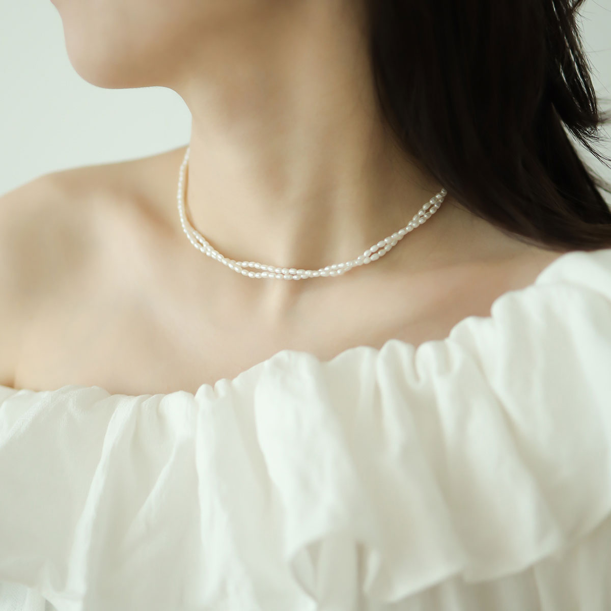 Women wear double pearl necklace.