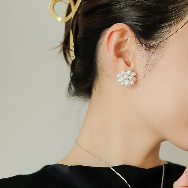 Women in black wear elegant earrings.