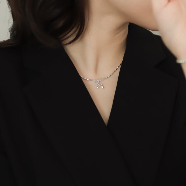 Women in black wear everyday necklace.