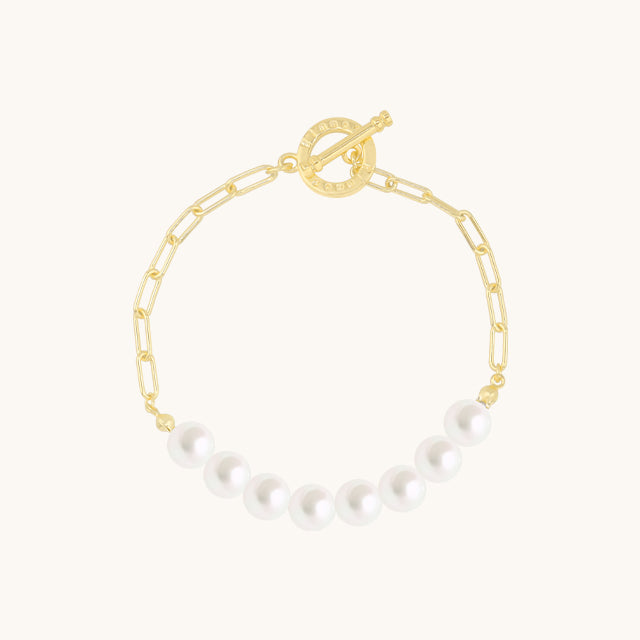 A gold chain and pearl bracelet.