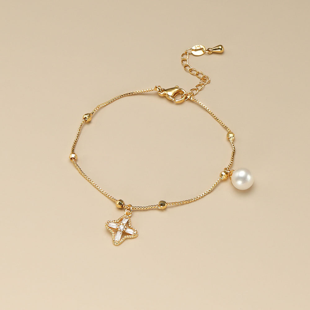 A gold and pearl bracelet.