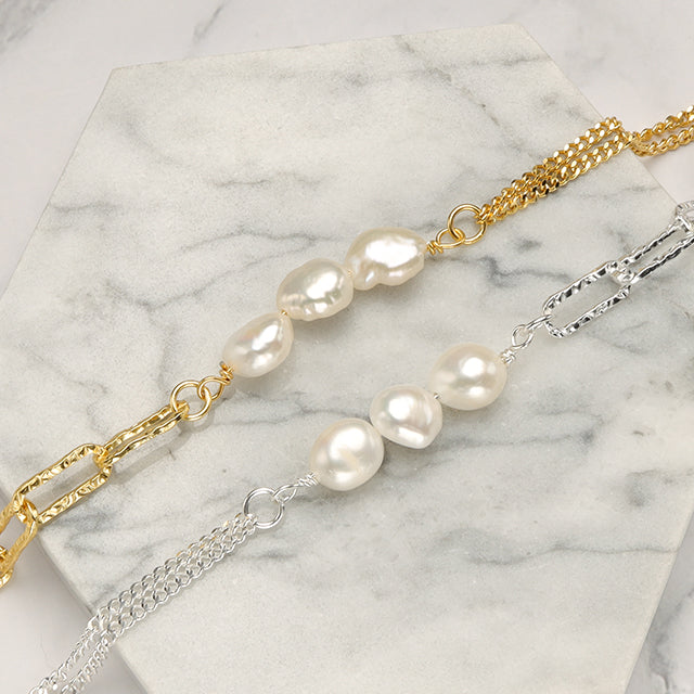 A close shot of gold and silver pearl bracelet.