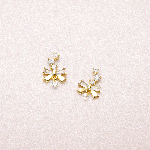 A pair of gold beauty bow tiny diamond earrings.