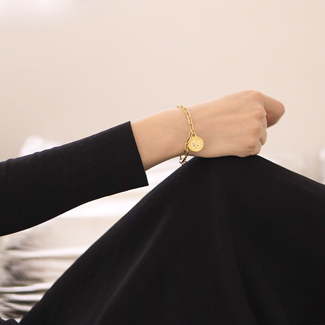 women dressed in black wear gold bracelet.