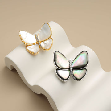 Two butterfly gold brooch pins.