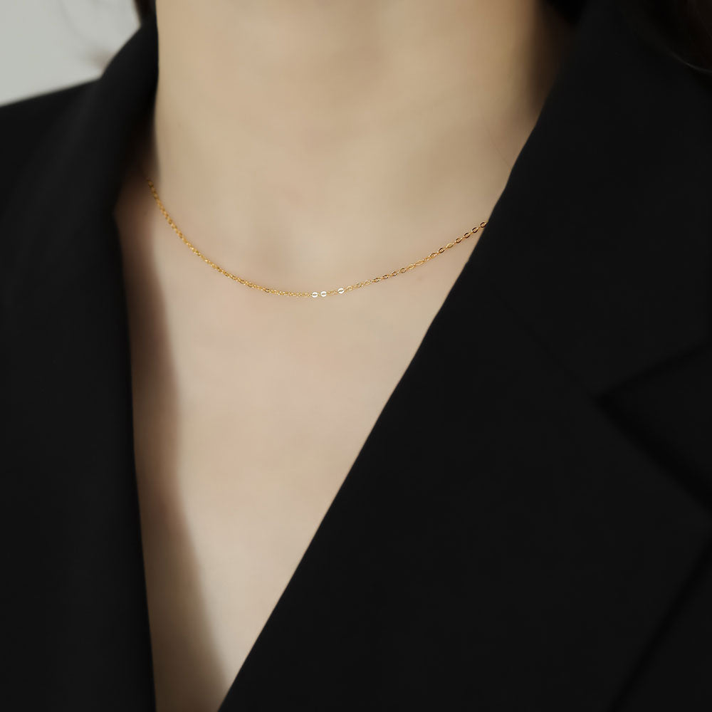 Women in black wear gold chain.