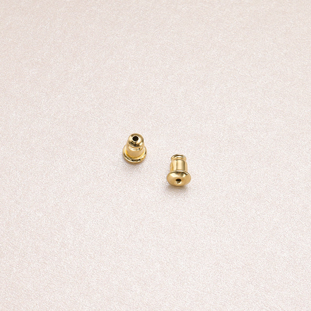 A pair of gold earring backs.