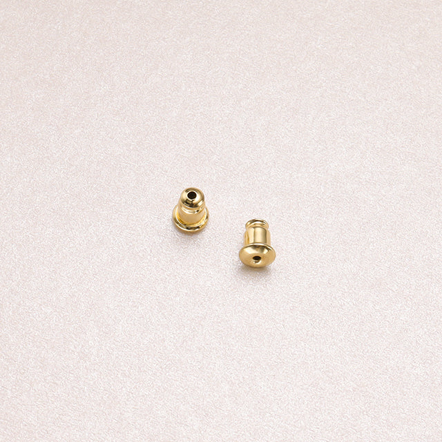 A pair of gold earrings backs.