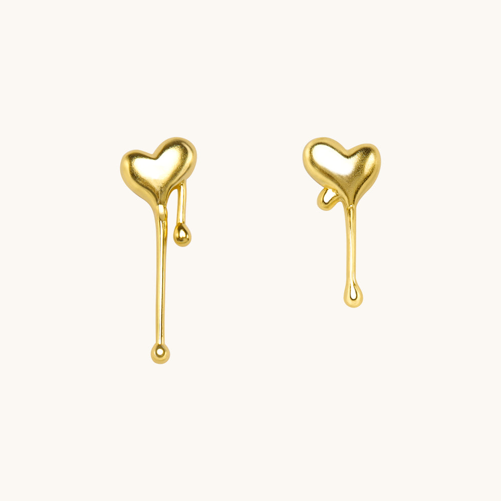 A pair of gold heart earrings.