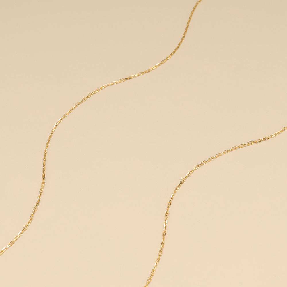 A close shot gold necklace chain.