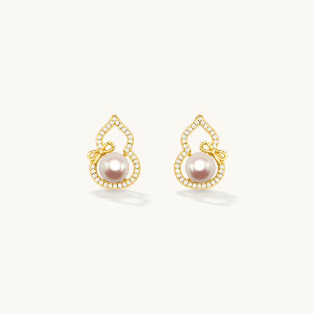 A pair of gold pearl earrings,