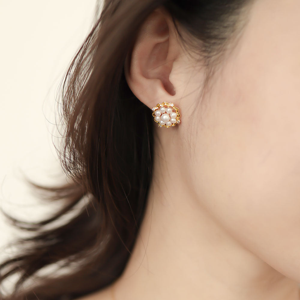 Women wear gold pearl stud earrings.