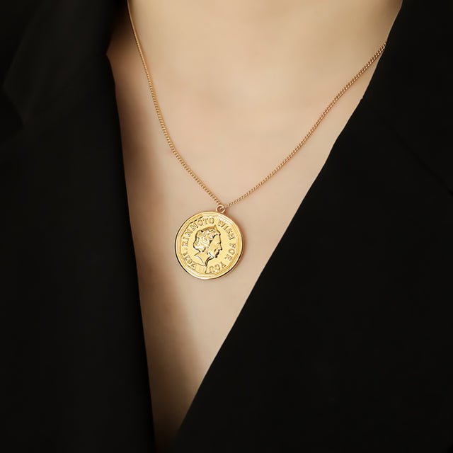 Big coin gold plated necklace on women neck.