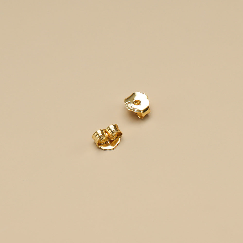 A pair of gold plated silver earring backs.