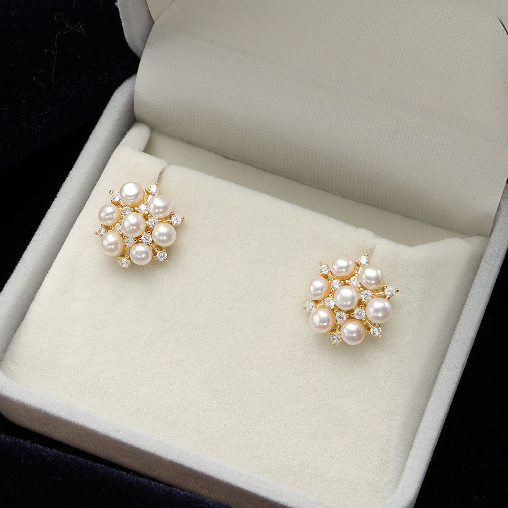 Gold snowflake pearl earrings.