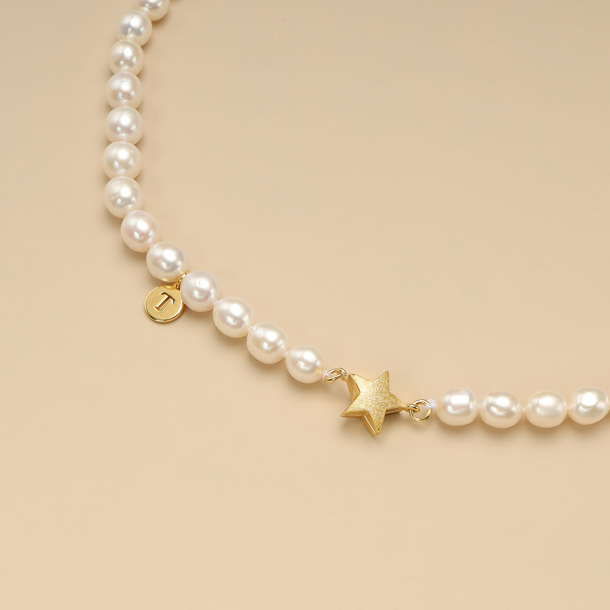 A gold star necklace with initial necklace.