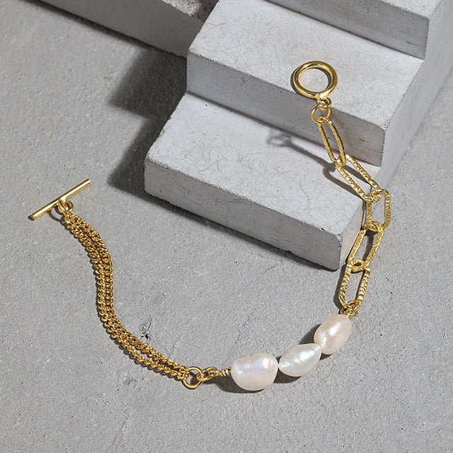 Gold stylish bracelet on cement block.