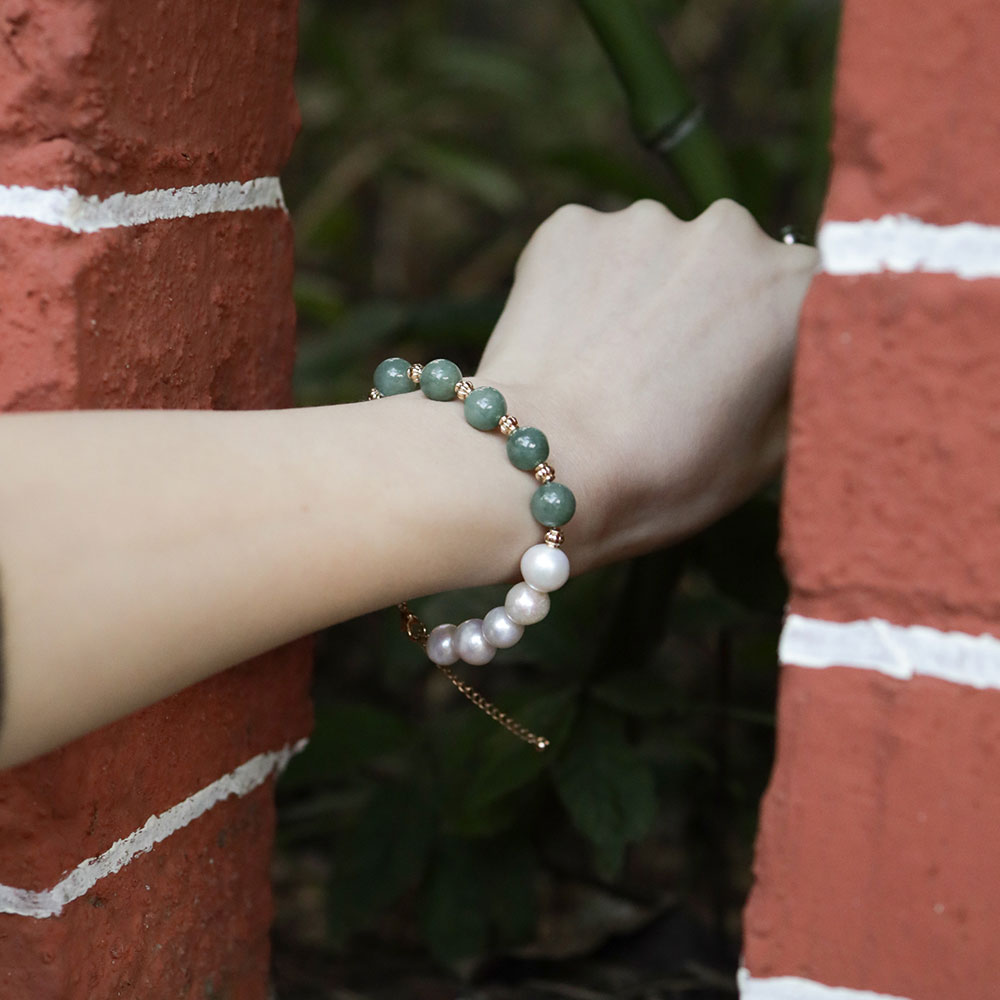 Women wear a green stone bracelet.