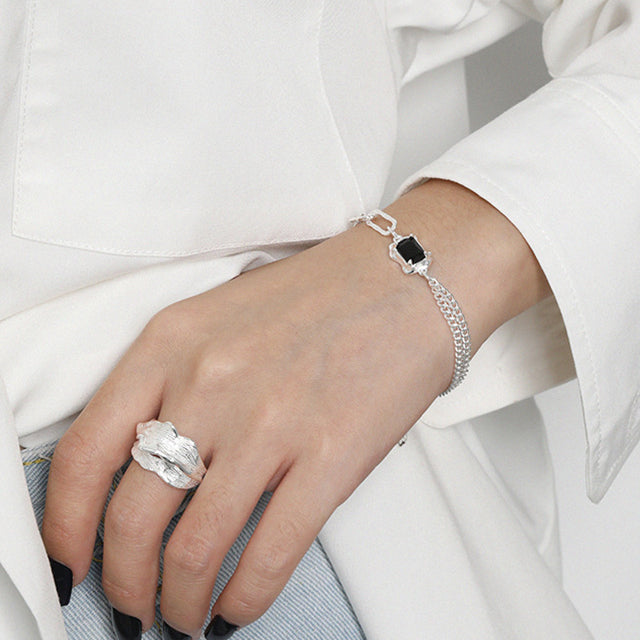 A women wear hand bracelet and silver ring.