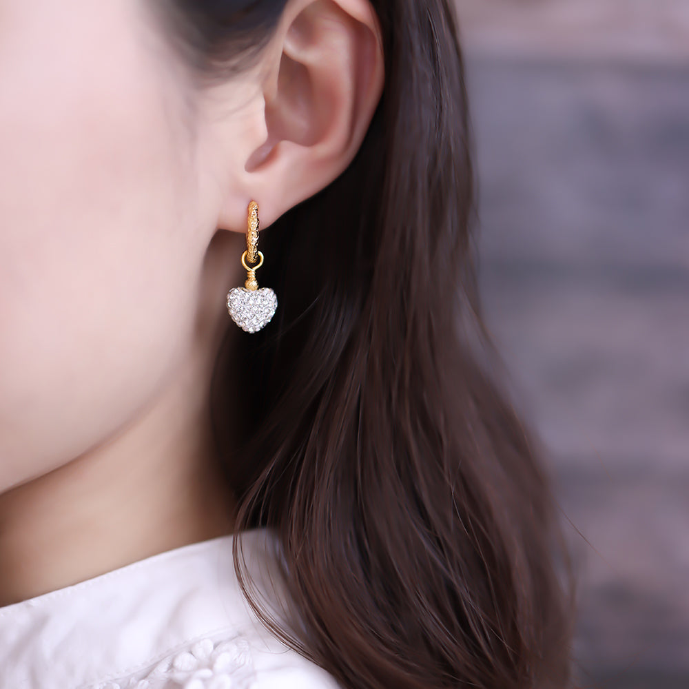 Women wear heart dangle earrings.