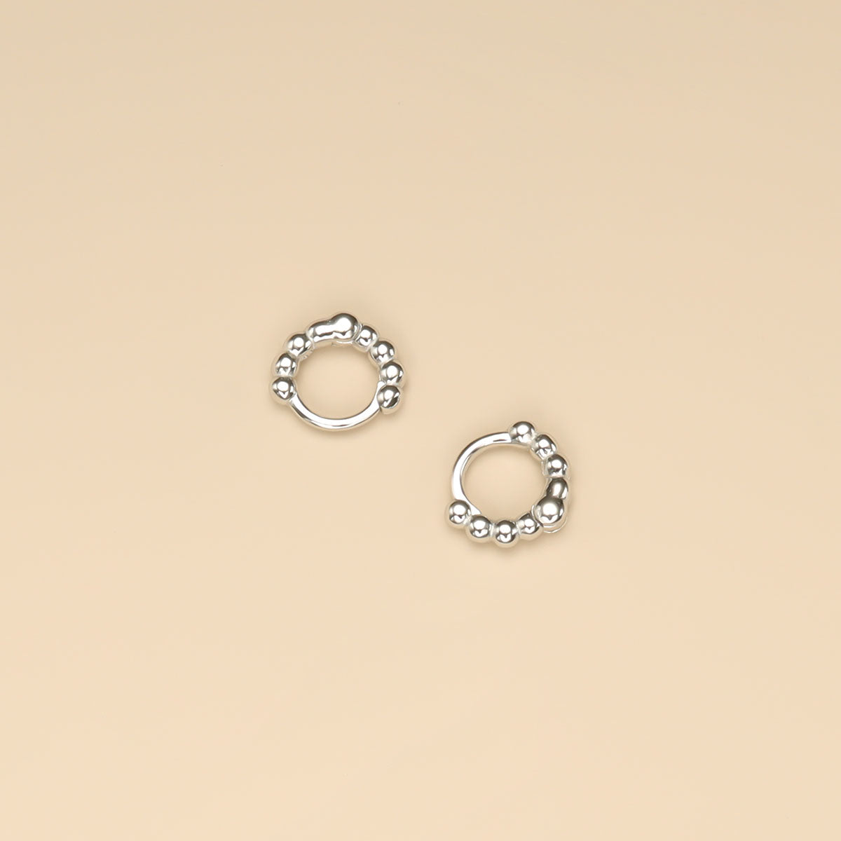 A pair of helix hoop earrings.