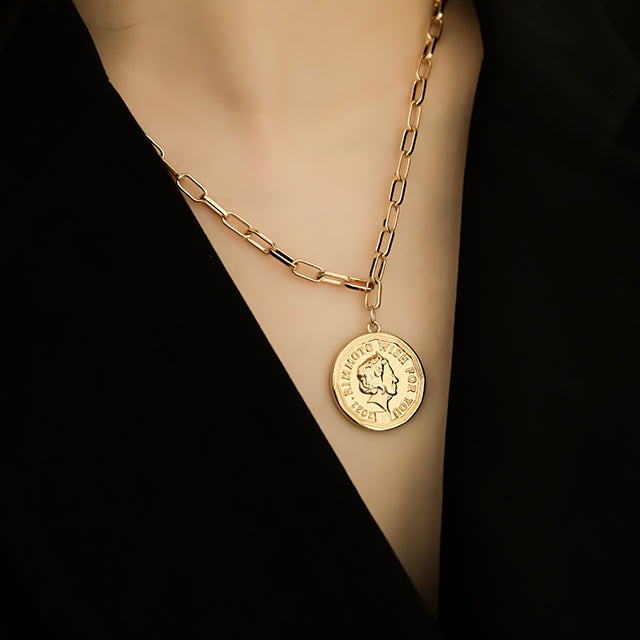 Long chain with coin pendant.