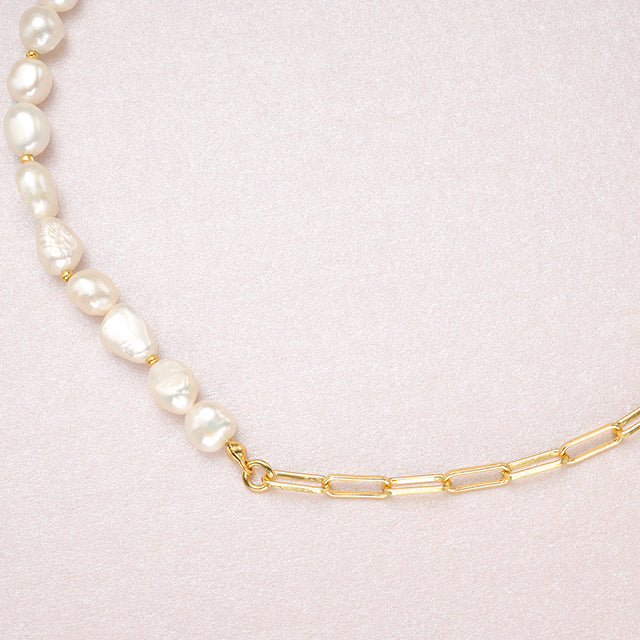 The juncture of pearl and chain necklace.