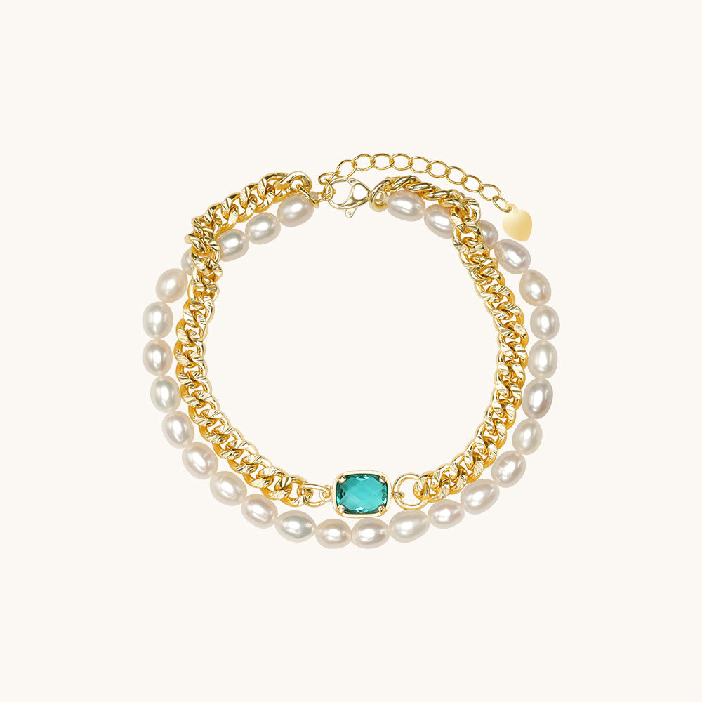 A pearl and gold chain bracelet.