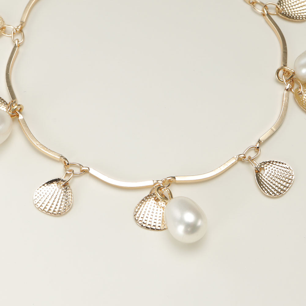 Pearl and shell gold bracelet.