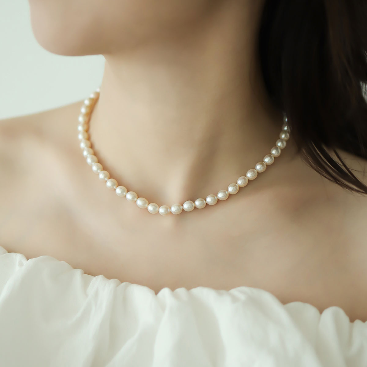 Women wear pearl bead necklace.