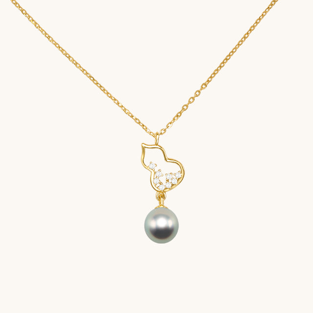 A gold pearl drop necklace.