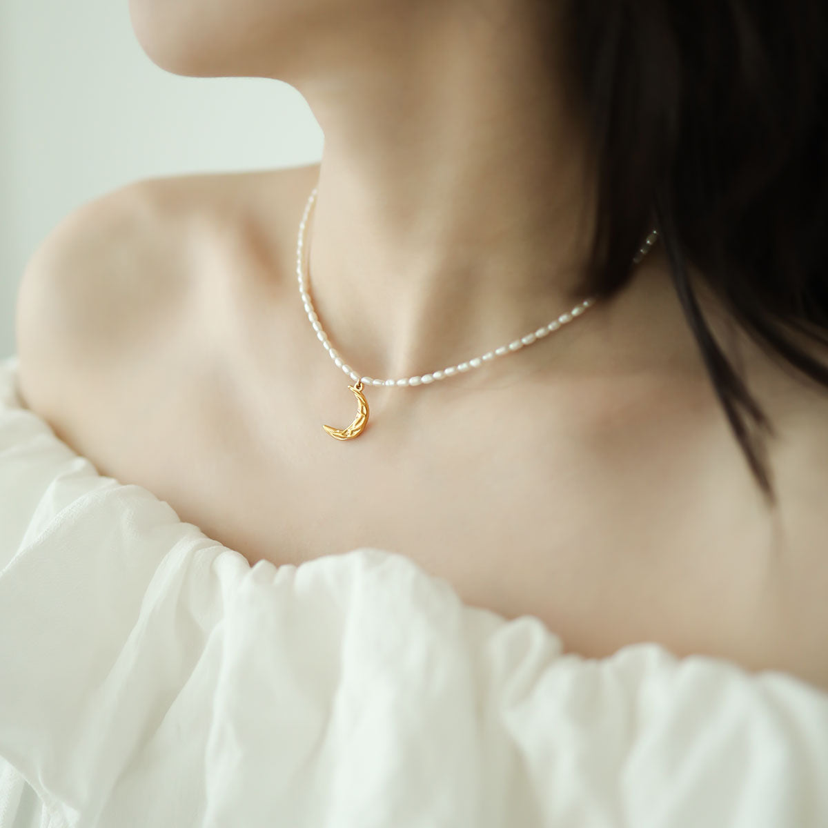 Women wear a pearl moon necklace.