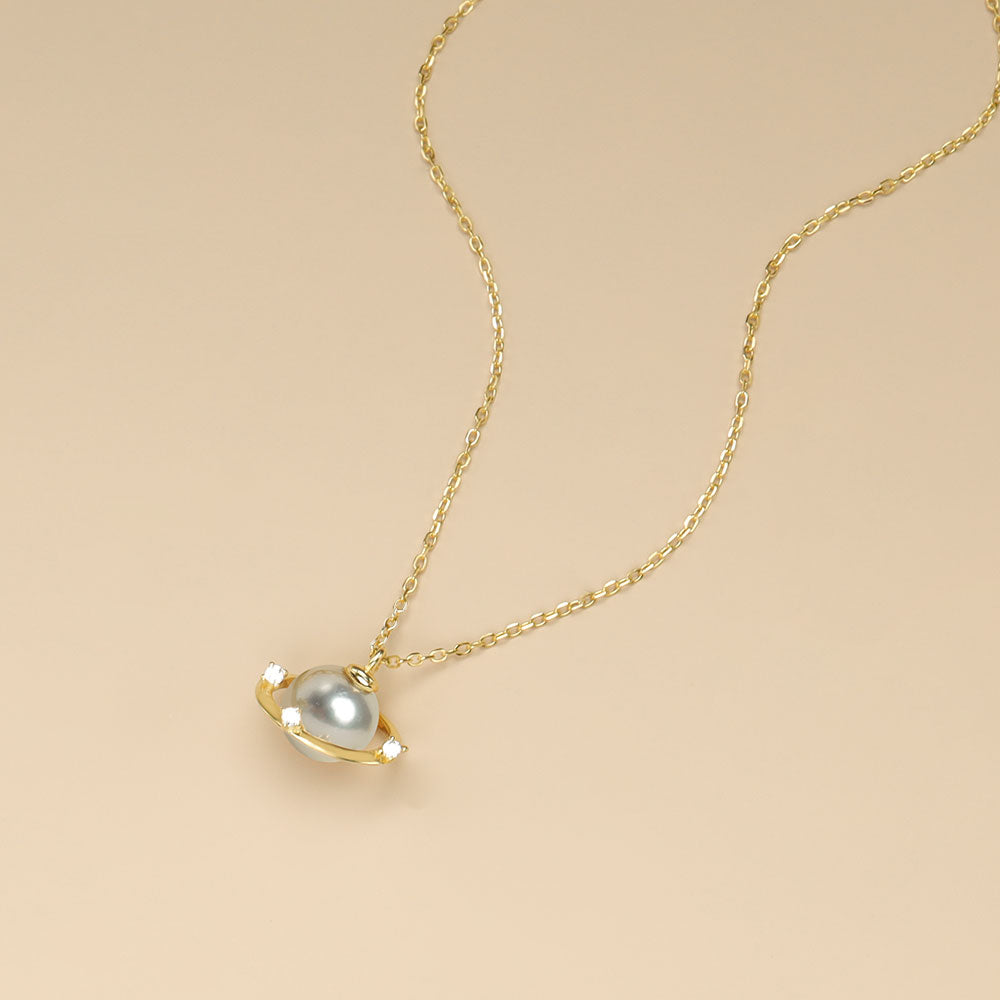 A grey pearl necklace with planet.