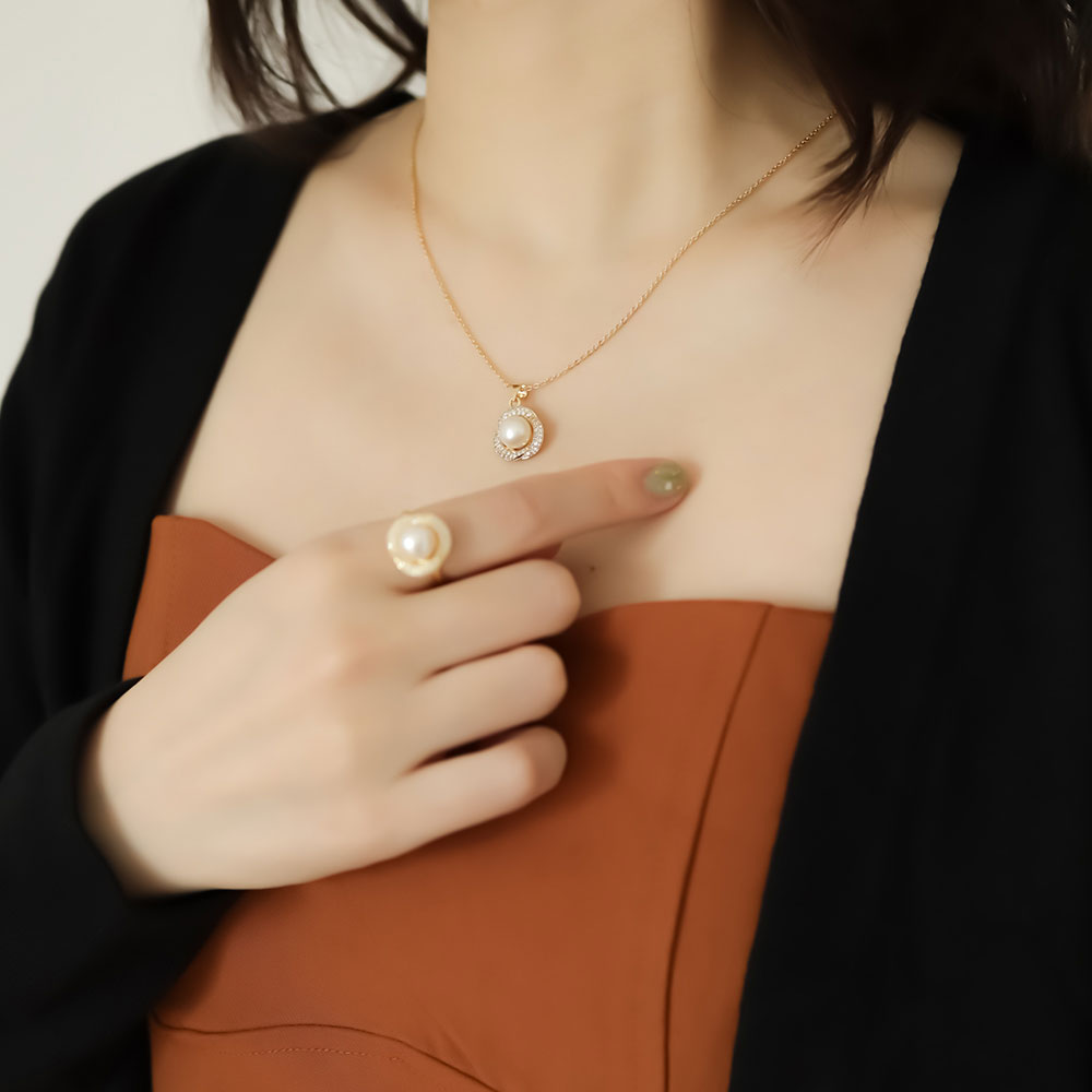 Women wear pearl ring and pearl necklace.