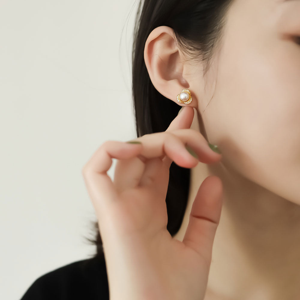 Women wear pearl statement earrings.