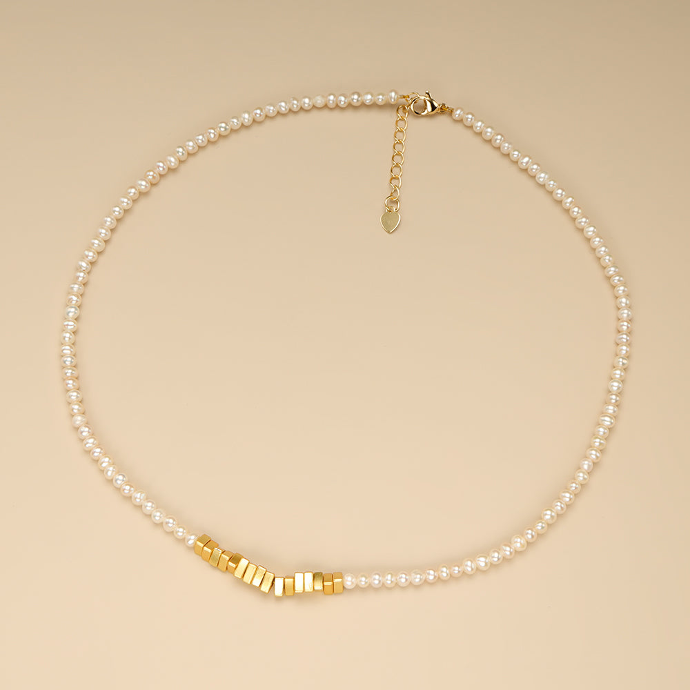 A pearl strand necklace.