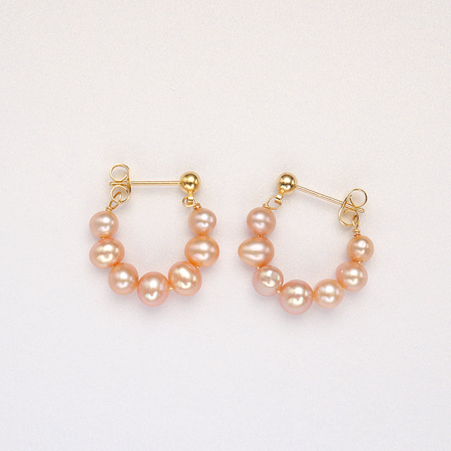 A pair of pink pearl new look earrings.